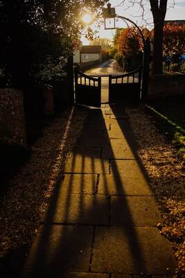 Walkway with gate in the sunset